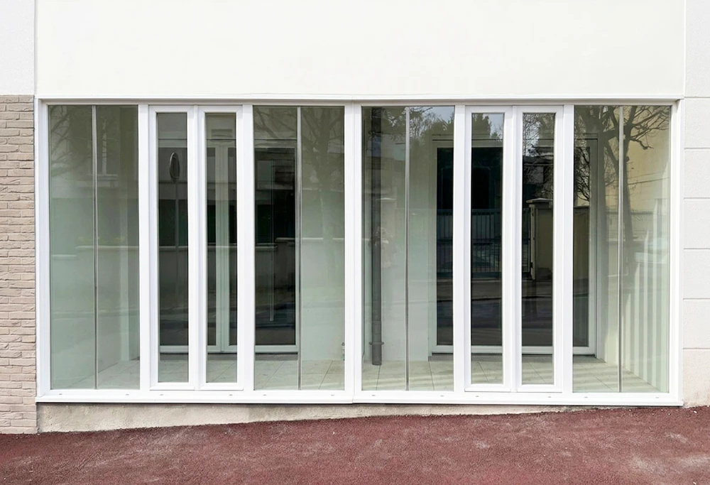 Véranda moderne attenante à maison individuelle avec toiture tuiles